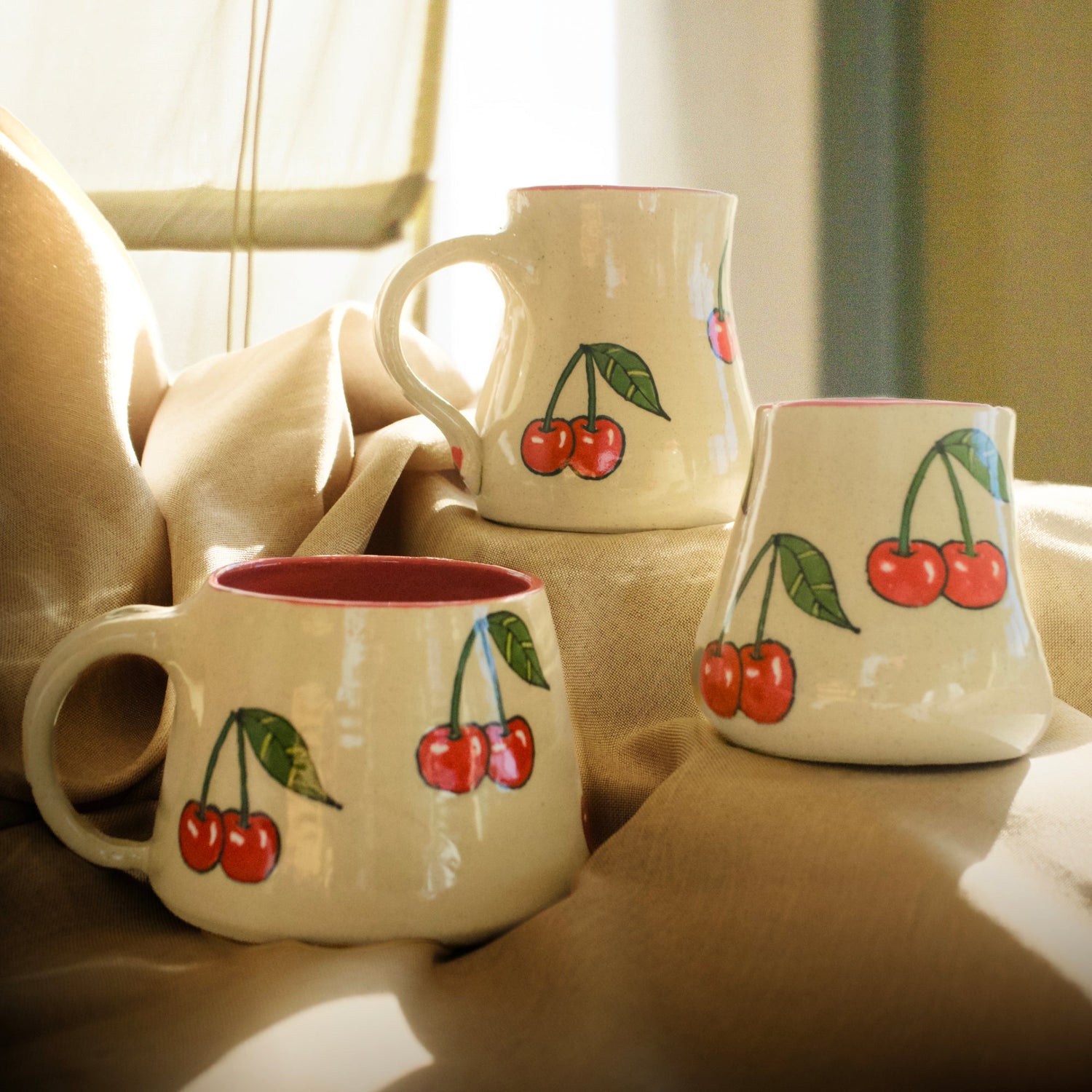 A Collection of mugs with fruit designs glazed on them