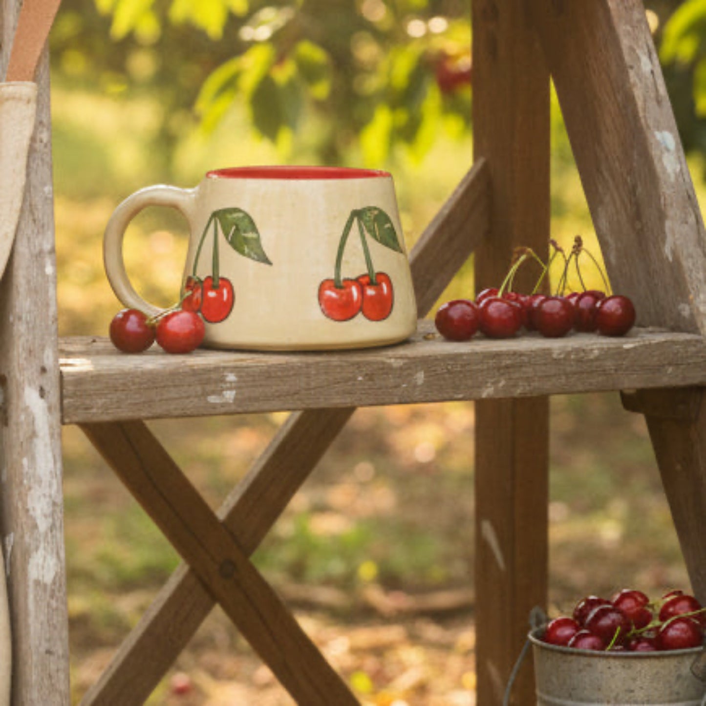 Ceramic mug with cherry design on a wooden surface