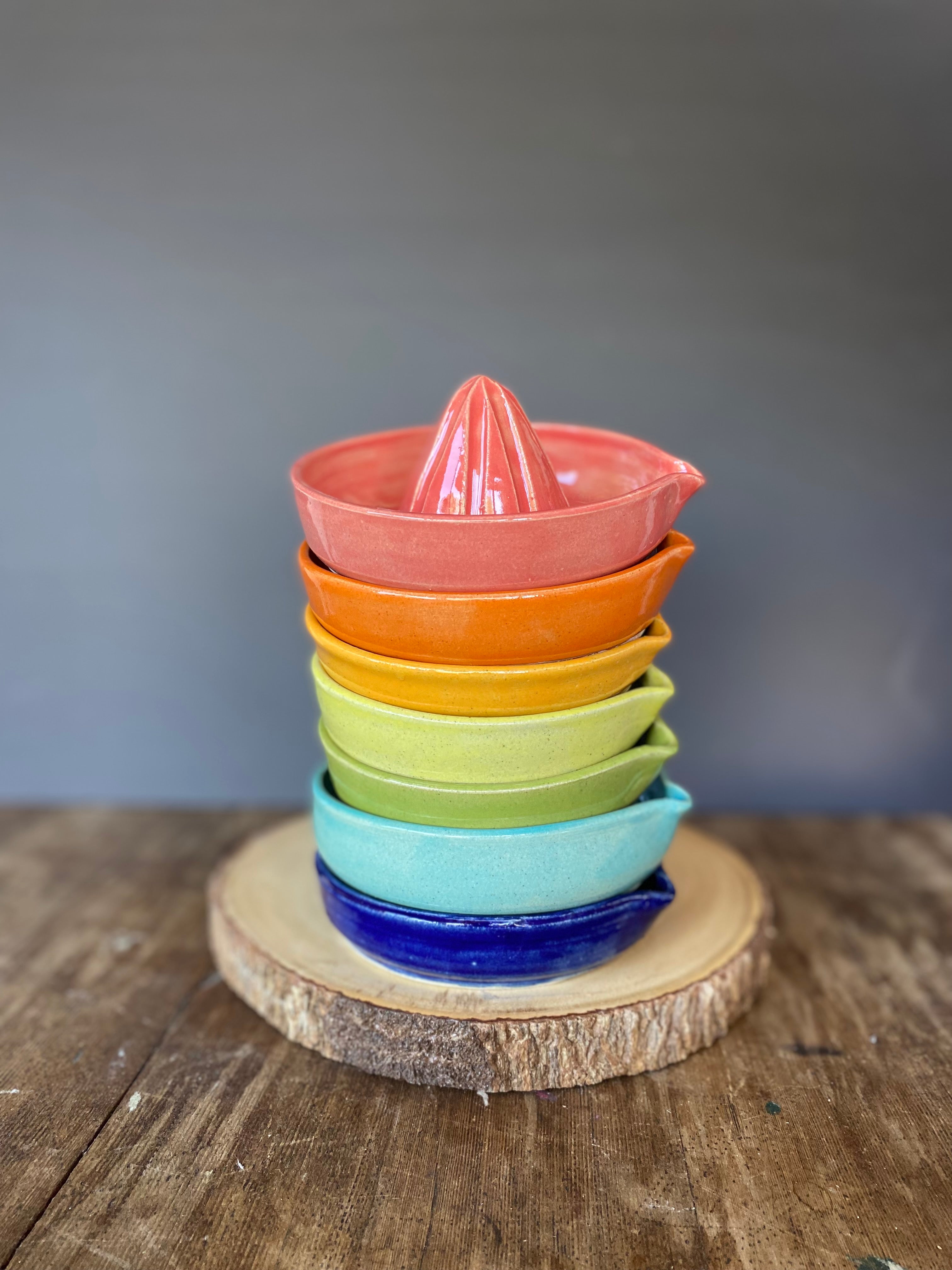 wheel thrown pottery citrus juicers in bright colours for your whismical, functional  kitchen decor